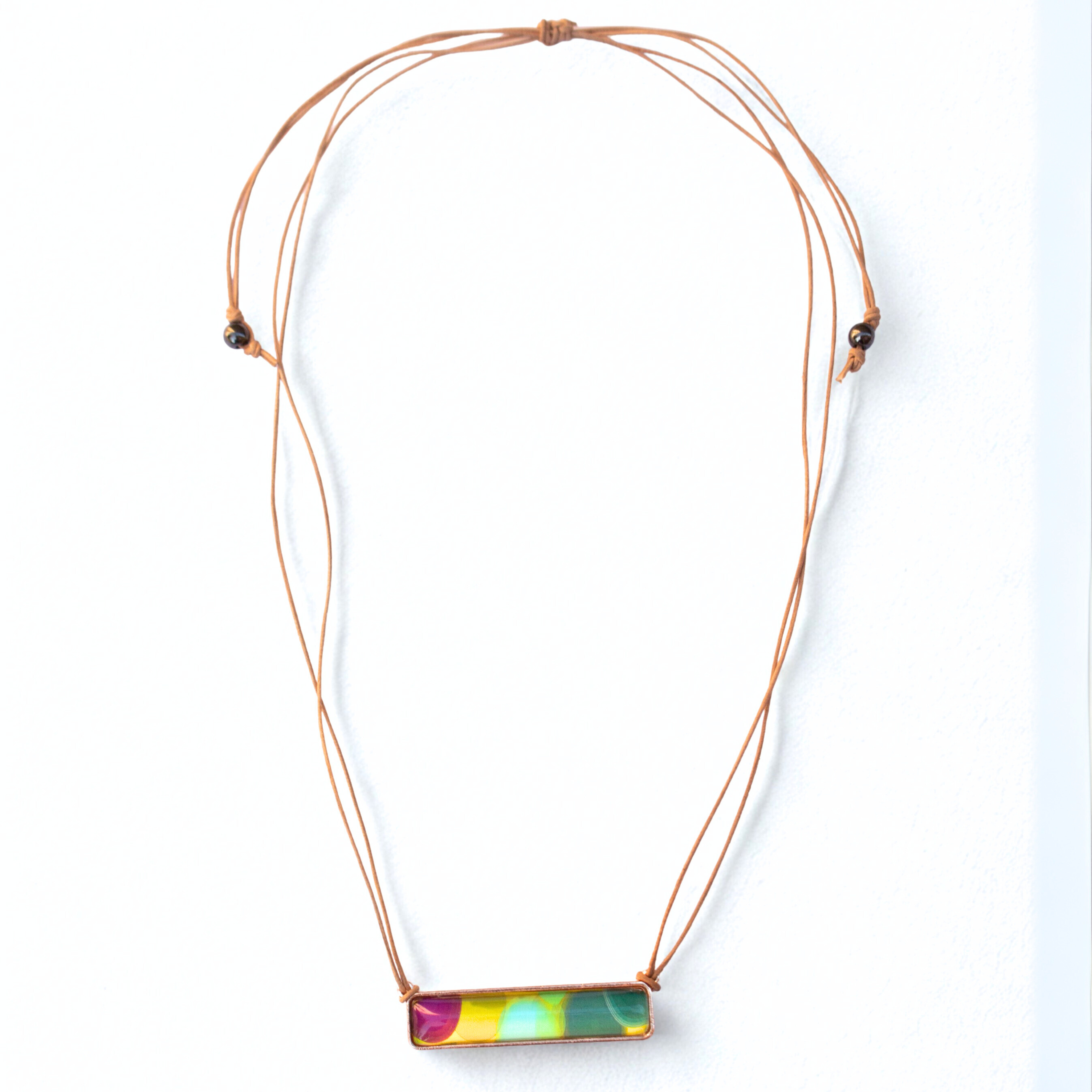 Necklace with a colorful rectangular pendant on a white background